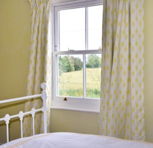 create the illusion of space in a small room with drapes and curtains